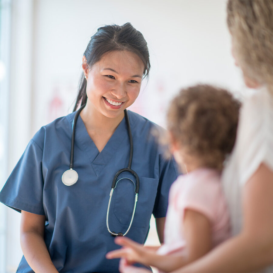 Physician Smiling at Young Patient Physician Smiling at Young Patient