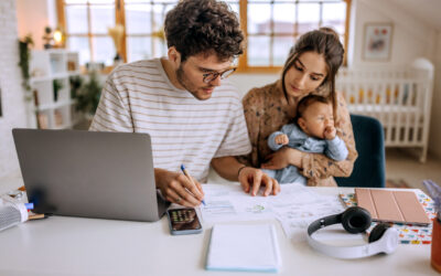 Young family with cute little baby boy going over finances at home